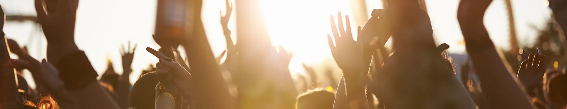 People raising their hands at an outdoor event